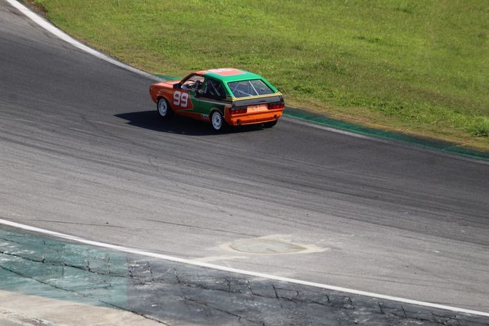 Carros passam pela Curva do Laranjinha em Interlagos, com a 'cratera' já coberta provisoriamente (Foto: Fernando Santos/Divulgação F-Vee)