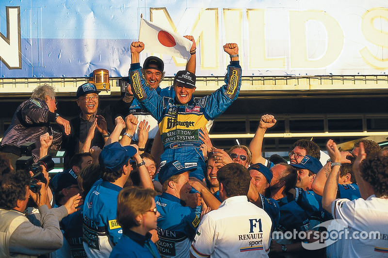 Race winner and World Champion Michael Schumacher, Benetton celebrates with Flavio Briatore and the team