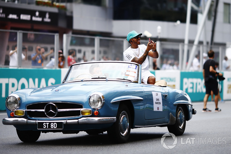 Lewis Hamilton, Mercedes AMG F1, waves from a Mercedes 190SL on the drivers parade