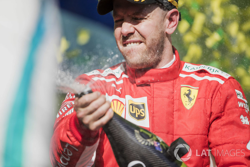 Sebastian Vettel, Ferrari, 1st position, celebrates on the podium with Champagne