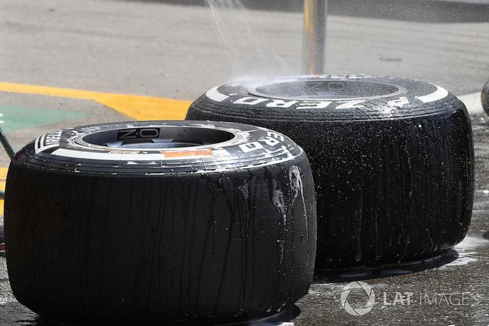 Red Bull Racing mechanic washes Pirelli tyres