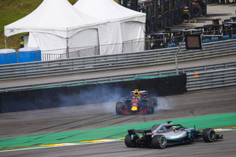 Lewis Hamilton, Mercedes AMG F1 W09, passes a spinning Max Verstappen, Red Bull Racing RB14 Tag Heuer, after the latter suffers a collision with Esteban Ocon, Force India VJM11 Mercedes.