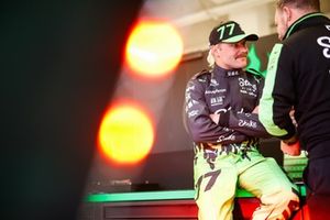 Valtteri Bottas, da Stake F1 Team KICK Sauber, fala com um colega de equipa na garagem