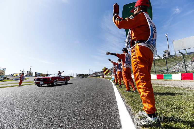 Marshals line the track as Kevin Magnussen, Haas F1 Team, passes in the drivers parade