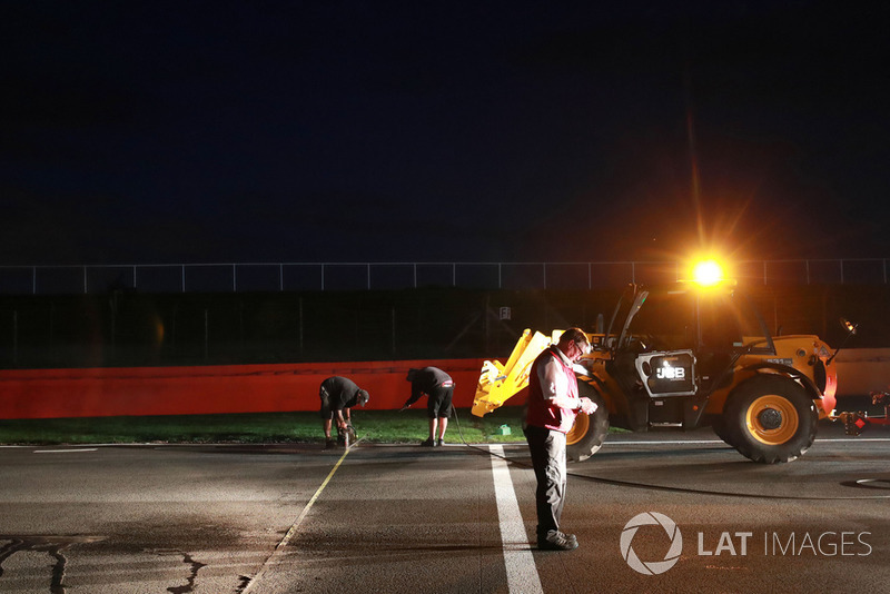 Crews work to improve drainage on the circuit before Sunday's race