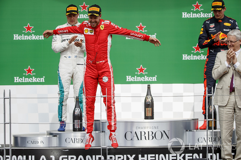 Sebastian Vettel, Ferrari, 1st position, leaps in celebration on the podium