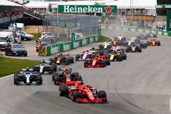 Sebastian Vettel, Ferrari SF71H, leads Max Verstappen, Red Bull Racing RB14, Valtteri Bottas, Mercedes AMG F1 W09, Lewis Hamilton, Mercedes AMG F1 W09, Kimi Raikkonen, Ferrari SF71H, Daniel Ricciardo, Red Bull Racing RB14, and the rest of the field at the start of the race