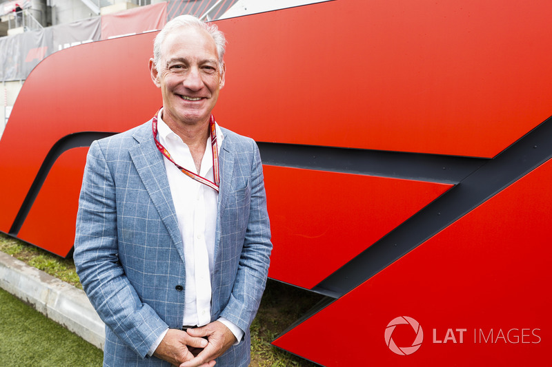 Greg Maffei, Chief Executive Officer, Liberty Media, in front of an F1 logo