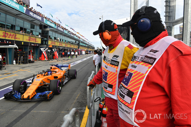 Marshal mengawasi Fernando Alonso, McLaren MCL33 di pit lane