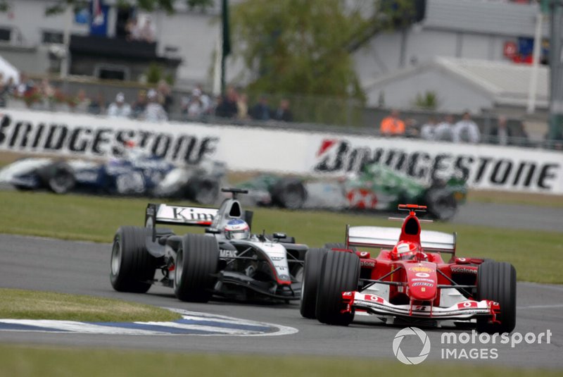 Michael Schumacher, Ferrari F2004, leads Kimi Raikkonen, McLaren Mercedes MP4/19B