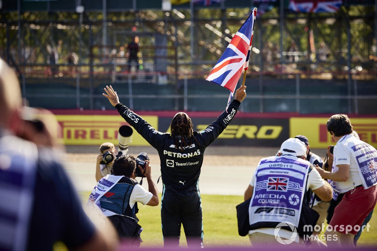 Lewis Hamilton, Mercedes , 1st position, celebrates with a Union flag after the race