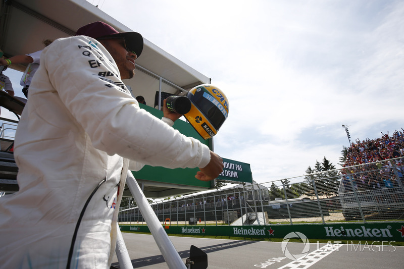 Lewis Hamilton, Mercedes AMG F1, shows off his Ayrton Senna helmet, a gift after equalling the Brazi