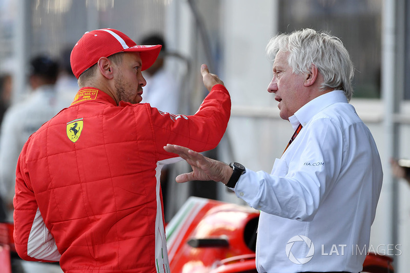 Pole sitter Sebastian Vettel, Ferrari and Charlie Whiting, FIA Delegate in parc ferme