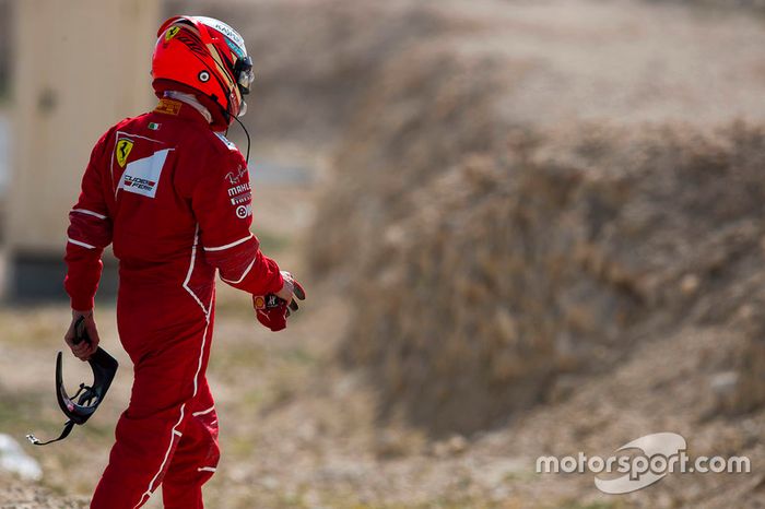 Kimi Raikkonen, Ferrari, walks back to his garage