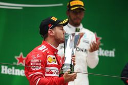 Sebastian Vettel, Ferrari kisses his trophy on the podium