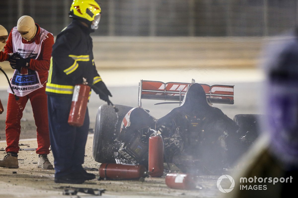 Marshals deal with the wreckage after a huge crash for Romain Grosjean, Haas VF-20, on the opening lap