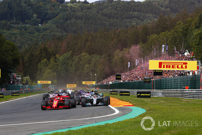 Sebastian Vettel, Ferrari SF71H, leads Lewis Hamilton, Mercedes AMG F1 W09, Sergio Perez, Racing Point Force India VJM11, and Esteban Ocon, Racing Point Force India VJM11, at the start
