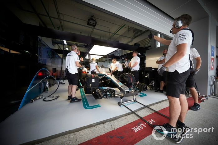 An engineer signals to his team mates as preparations are made to send Lewis Hamilton, Mercedes AMG F1 W09