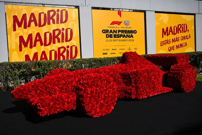 Gran Premio de España signage and branding behind a floral racing car