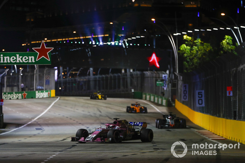 Sergio Perez, Racing Point Force India VJM11, leads Romain Grosjean, Haas F1 Team VF-18, and Fernando Alonso, McLaren MCL33