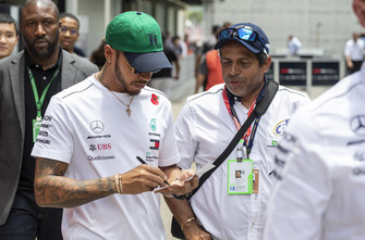 Lewis Hamilton, Mercedes AMG F1 signs a autograph for a fan