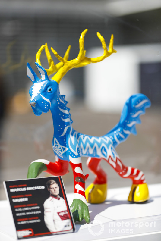 An Alebrijes sculpture on an autograph table for Marcus Ericsson, Sauber