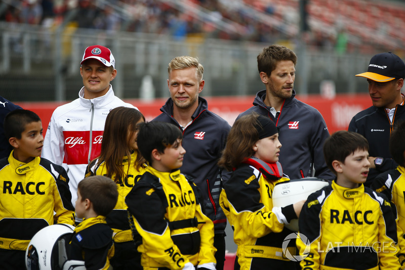 Young karters backed by the RACC, Spain's largest auto club, pose with Marcus Ericsson, Sauber, Kevin Magnussen, Haas F1 Team, Romain Grosjean, Haas F1 Team, and Stoffel Vandoorne, McLaren