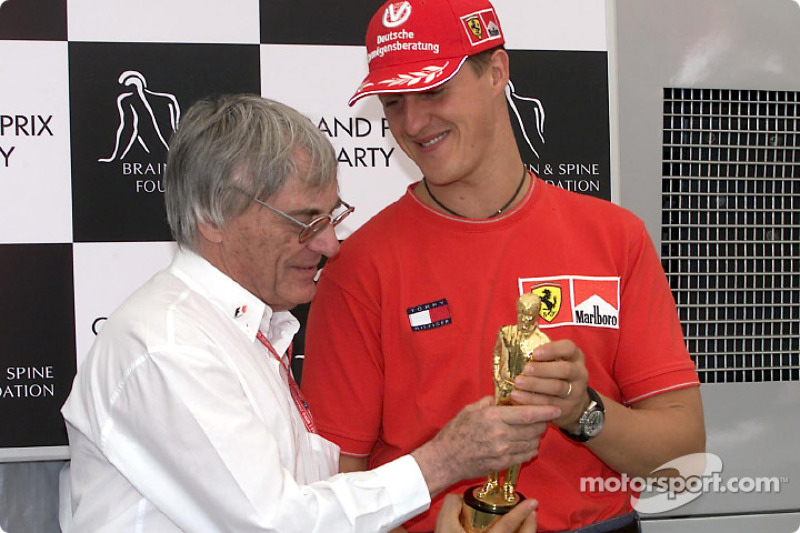 Michael Schumacher receive his 'Bernie' from Bernie Ecclestone