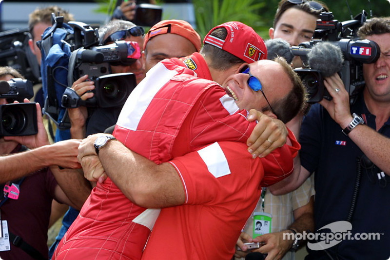 Michael Schumacher being congratulated by Rubens Barrichello