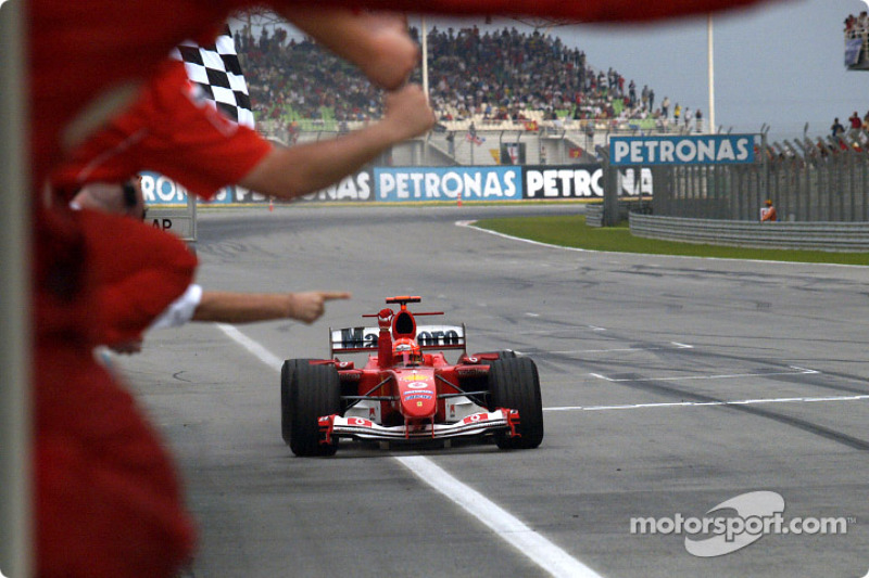 Michael Schumacher takes checkered flag