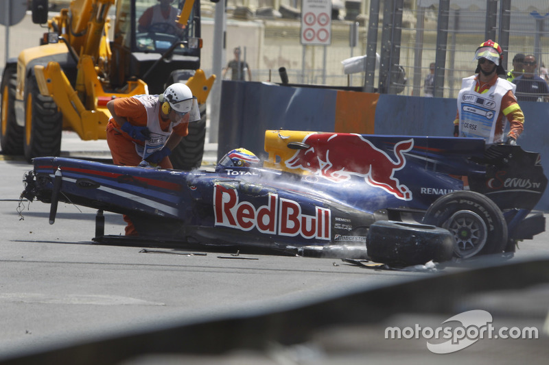 Marshals remove the wrecked car of Mark Webber, Red Bull Racing