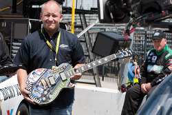Sam Bass holds the Gibson guitar trophy that he painted for the Nashville 300 race