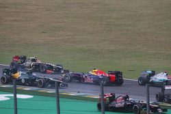 Sebastian Vettel, Red Bull Racing survives a crash with Sergio Perez, Sauber and Bruno Senna, Williams at the start of the race
