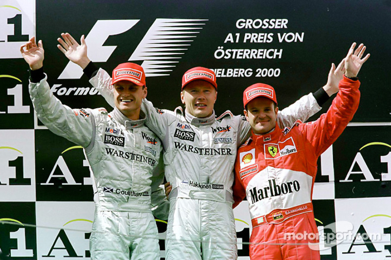 Podium: race winner Mika Hakkinen, second place David Coulthard, third place Rubens Barrichello