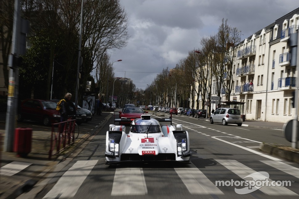 Tom Kristensen drives the Audi R18 e-tron quattro through the streets of downtown Le Mans