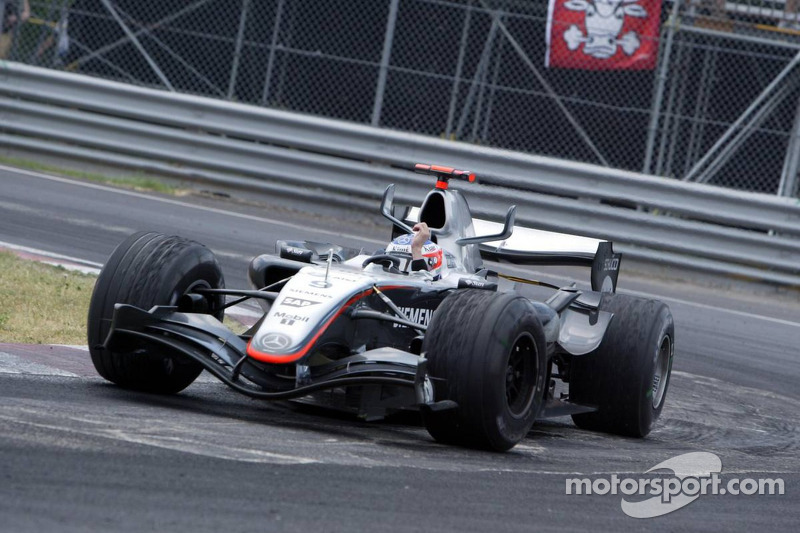 Race winner Kimi Raikkonen celebrates