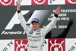 Podium: race winner Kimi Raikkonen celebrates