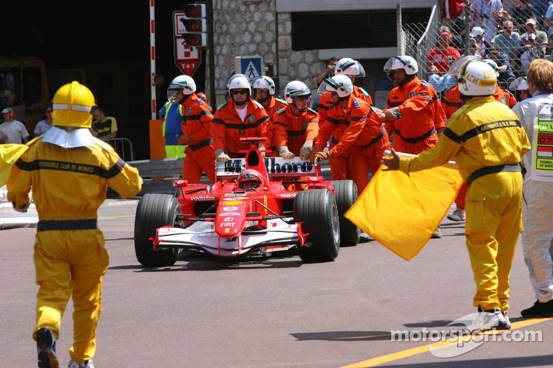 Michael Schumacher empujado al Parc Fermé