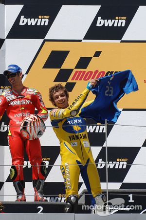 Podium: race winner Valentino Rossi puts on the Team Italia shirt