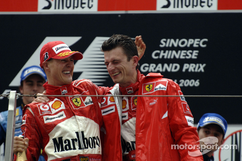 Podium: race winner Michael Schumacher celebrates with Chris Dyer