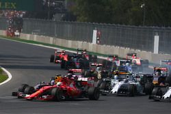 Sebastian Vettel, Ferrari SF15-T and Daniel Ricciardo, Red Bull Racing RB11 make contact at the start of the race