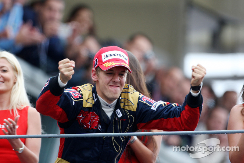 Podium: race winner Sebastian Vettel celebrates